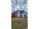 Charming home exterior with a brick patio, well-maintained lawn, and inviting architectural details at 10607 Old Bridge Ln, Charlotte, NC 28269