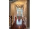 Spacious foyer featuring hardwood floors, chandelier, and bright front door at 10607 Old Bridge Ln, Charlotte, NC 28269