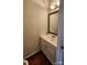 Charming half bathroom with decorative mirror, modern sink, and wood floors at 10607 Old Bridge Ln, Charlotte, NC 28269