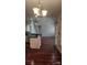Open-concept kitchen features a large island with modern lighting and hardwood floors at 10607 Old Bridge Ln, Charlotte, NC 28269
