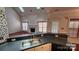 Kitchen features double sinks, sleek black countertops, and a modern design at 10607 Old Bridge Ln, Charlotte, NC 28269
