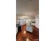 Bright kitchen with an island, white cabinets, and hardwood floors at 10607 Old Bridge Ln, Charlotte, NC 28269