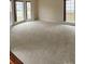 Spacious living room with wall to wall carpet and lots of windows at 10607 Old Bridge Ln, Charlotte, NC 28269
