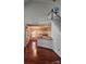 Hardwood floors and open floor plan lead to staircase and modern kitchen at 10607 Old Bridge Ln, Charlotte, NC 28269