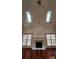 Bright living room features skylights, a fireplace, and gleaming wood floors at 10607 Old Bridge Ln, Charlotte, NC 28269