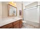 Bathroom with a white vanity, decorative mirror, toilet, and shower-tub combination at 1103 Phar Lap Dr, Indian Trail, NC 28079