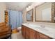 Bathroom featuring a double vanity, stylish mirrors, and a shower with a blue curtain at 1103 Phar Lap Dr, Indian Trail, NC 28079