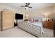 Spacious bedroom with a tufted headboard, ceiling fan, and matching nightstands at 1103 Phar Lap Dr, Indian Trail, NC 28079