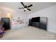 Bright bedroom with a daybed, ceiling fan, and black dressers at 1103 Phar Lap Dr, Indian Trail, NC 28079