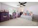 Bright bedroom with a daybed, ceiling fan, and a dollhouse at 1103 Phar Lap Dr, Indian Trail, NC 28079