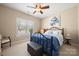 Comfortable bedroom with an iron bed frame, a window, and a ceiling fan at 1103 Phar Lap Dr, Indian Trail, NC 28079