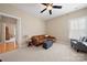 Bonus room with hardwood floors, a leather couch, and natural light at 1103 Phar Lap Dr, Indian Trail, NC 28079