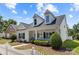 Attractive home with a covered porch, manicured bushes, and a classic white picket fence at 1103 Phar Lap Dr, Indian Trail, NC 28079