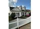 Beautiful white house with black shutters, complemented by colorful flowers and a white picket fence at 1103 Phar Lap Dr, Indian Trail, NC 28079
