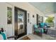 A cozy front porch with stylish seating, featuring a decorative fan and a patterned rug, creating a welcoming entrance at 1103 Phar Lap Dr, Indian Trail, NC 28079
