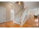Bright hallway with hardwood floors, a staircase, and entry to other rooms at 1103 Phar Lap Dr, Indian Trail, NC 28079