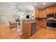 Open-concept kitchen boasts hardwood floors, stainless steel appliances, granite countertops, and a view into the living space at 1103 Phar Lap Dr, Indian Trail, NC 28079
