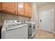 Well-equipped laundry room with wooden cabinets and modern LG washer and dryer units at 1103 Phar Lap Dr, Indian Trail, NC 28079