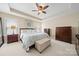 Main bedroom featuring a tray ceiling, neutral walls and carpet, and ample furniture at 1103 Phar Lap Dr, Indian Trail, NC 28079
