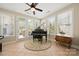 Music room featuring a Kawai grand piano, tile floors and many windows at 1103 Phar Lap Dr, Indian Trail, NC 28079