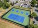 Aerial view of tennis courts surrounded by lush landscaping and neighborhood homes at 1103 Phar Lap Dr, Indian Trail, NC 28079