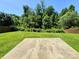 Spacious backyard featuring green grass and tree line at 11109 Pond Valley Ct, Charlotte, NC 28269