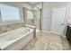 Modern bathroom featuring a separate tub and shower with tile surround at 11109 Pond Valley Ct, Charlotte, NC 28269