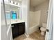 A clean bathroom featuring a single sink vanity, toilet, and a shower-tub combo at 11109 Pond Valley Ct, Charlotte, NC 28269