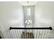 A foyer with chandelier lighting from the top of the stairwell with railing and window at 11109 Pond Valley Ct, Charlotte, NC 28269