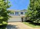 Beautiful two-story home with a two-car garage, a front porch, a well-manicured lawn and mature trees at 11109 Pond Valley Ct, Charlotte, NC 28269