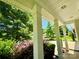 Inviting front porch with classic columns and lush landscaping offering an intimate outdoor relaxation space at 11109 Pond Valley Ct, Charlotte, NC 28269