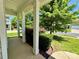 Charming front porch with white columns surrounded by manicured shrubs and greenery, leading to a welcoming entrance at 11109 Pond Valley Ct, Charlotte, NC 28269