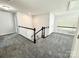 Spacious upstairs hallway with neutral walls and gray carpet leading to other rooms at 11109 Pond Valley Ct, Charlotte, NC 28269