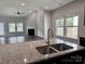 Open kitchen with granite countertops and a view of the living room at 11109 Pond Valley Ct, Charlotte, NC 28269