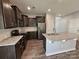 Kitchen featuring granite countertops, dark cabinets, and stainless steel appliances at 11109 Pond Valley Ct, Charlotte, NC 28269