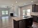 Bright open kitchen with granite countertops and view of living room fireplace at 11109 Pond Valley Ct, Charlotte, NC 28269