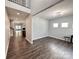Bright living room with hardwood floors, two windows, and neutral paint at 11109 Pond Valley Ct, Charlotte, NC 28269