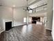Open-concept living room featuring a fireplace, dark floors, and views into the kitchen at 11109 Pond Valley Ct, Charlotte, NC 28269