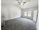 Bright primary bedroom with plush carpet, ample natural light, and a ceiling fan at 11109 Pond Valley Ct, Charlotte, NC 28269