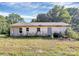 Back exterior of home with overgrown landscaping at 112 Harmony Trl, Gastonia, NC 28056