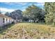 A spacious backyard featuring multiple outbuildings, including metal sheds and a wooded area at 112 Harmony Trl, Gastonia, NC 28056
