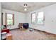 Spacious bedroom with two windows, hardwood floors, a ceiling fan, and peeling paint at 112 Harmony Trl, Gastonia, NC 28056