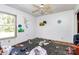 Interior shot of untidy bedroom with painted walls, windows, and a ceiling fan at 112 Harmony Trl, Gastonia, NC 28056
