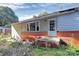 Exterior view of house with red brick foundation and white door with window panes at 112 Harmony Trl, Gastonia, NC 28056