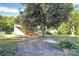 View of house and large front yard with mature shade tree at 112 Harmony Trl, Gastonia, NC 28056