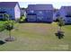 Expansive backyard featuring a well-maintained lawn and a black metal fence at 1141 Overlake Dr, Belmont, NC 28012