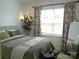 Cozy bedroom with a well-made bed and patterned curtains, illuminated by natural light at 1141 Overlake Dr, Belmont, NC 28012