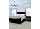 Bedroom with a four-poster bed, tray ceiling with chandelier, and bedside lamps at 1141 Overlake Dr, Belmont, NC 28012