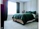 Tranquil bedroom with a plush, green bed and natural light coming in at 1141 Overlake Dr, Belmont, NC 28012