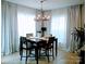 Dining room with large windows, hardwood floors, and a modern chandelier at 1141 Overlake Dr, Belmont, NC 28012